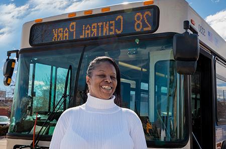 Tasha Clavo stands in front of her bus, which operates on route 28